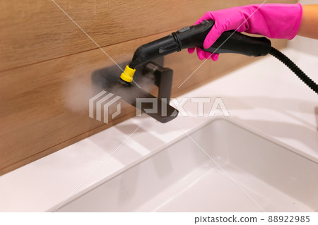 Cleaning the faucet from fungi and dirt with steam cleaner. Bathroom cleaning process 88922985