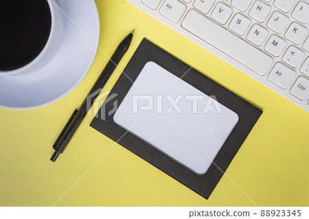 Directly above view of office desk table with yellow background. Copy space. Directly above view of office desk table with yellow background. Copy space. 88923345