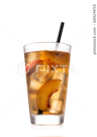 Glass of peach tea with ice cubes Glass of peach tea with ice cubes 88924059