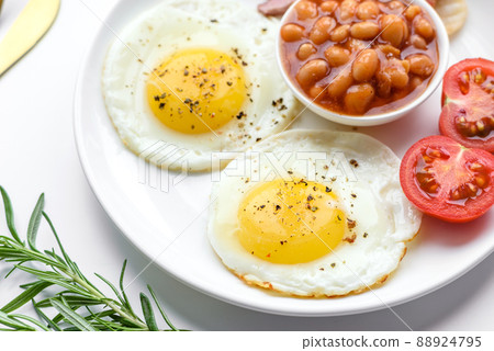 English breakfast with fried eggs, bacon, beans, tomatoes, spices and herbs English breakfast with fried eggs, bacon, beans, tomatoes, spices and herbs 88924795
