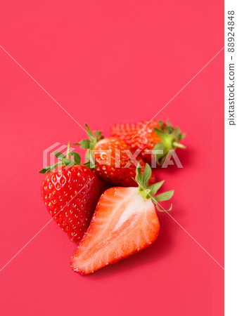 Ripe juicy orgaic strawberries on a red background. Ripe juicy orgaic strawberries on a red background. 88924848