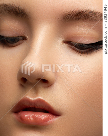 Closeup of beauty woman with clean shiny skin and natural cosmetics. Beautiful extrem eyelash and plump lips of a well-groomed girl demonstrate spa procedures, injections in a beauty parlor Closeup of beauty woman with clean shiny skin and natural cosmetics. Beautiful extrem eyelash and plump lips of a well-groomed girl demonstrate spa procedures, injections in a beauty parlor 88924949