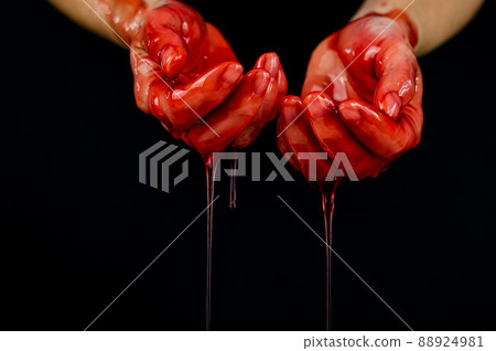 Women's hands in a viscous red liquid similar to blood. Women's hands in a viscous red liquid similar to blood. 88924981