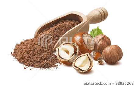 Hazelnuts and wooden scoop with cocoa powder isolated on white background. Hazelnuts and wooden scoop with cocoa powder isolated on white background. 88925262