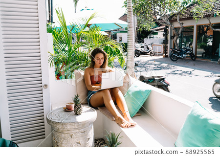 Thoughtful woman working on laptop 88925565