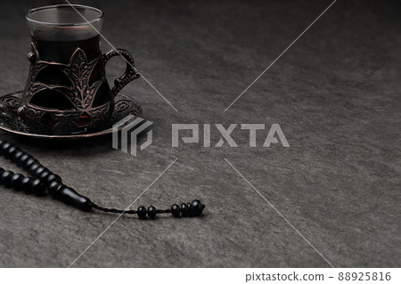 Glass of tea and rosary beads Glass of tea and rosary beads 88925816
