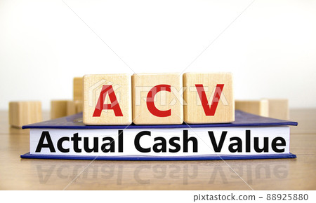 ACV actual cash value symbol. Concept words ACV actual cash value on wooden cubes on book on a beautiful wooden table, white background. Business and ACV actual cash value concept. Copy space. 88925880