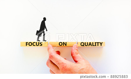 Focus on quality symbol. Concept words Focus on quality on blocks on beautiful white table white background. Businessman hand. Business, focus on quality concept. Copy space. 88925883