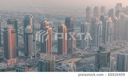 JLT skyscrapers near Sheikh Zayed Road aerial timelapse. Residential buildings and villas behind 88926409