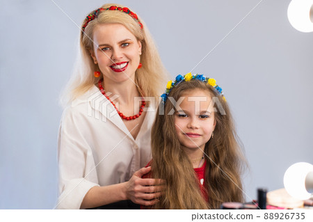 Portrait of young blonde woman and little girl with creative makeup. 88926735