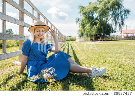 Agritourism and Farm Tours, Farm Cottagecore Weekend Trip. Farm Trips For Peaceful Weekend. A woman in rustic dress and with wildflowers in front of straw bales Agritourism and Farm Tours, Farm Cottagecore Weekend Trip. Farm Trips For Peaceful Weekend. A woman in rustic dress and with wildflowers in front of straw bales 88927437