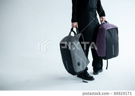 stylish hipster person holding modern backpack bag on white background stylish hipster person holding modern backpack bag on white background 88929171
