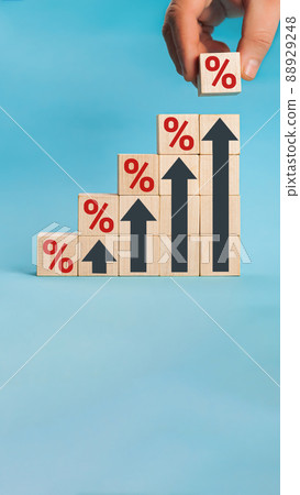Wooden blocks with percentage sign and arrow up, financial growt Wooden blocks with percentage sign and arrow up, financial growt 88929248