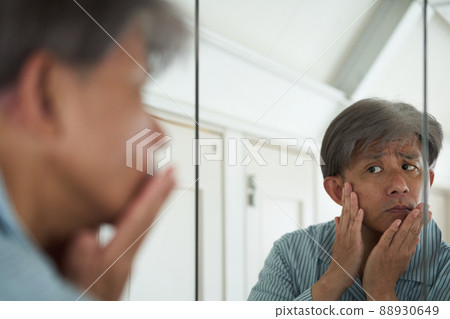 A man looking in the mirror A man looking in the mirror 88930649