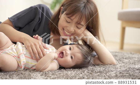 Baby and mom lying on the floor Baby and mom lying on the floor 88931531
