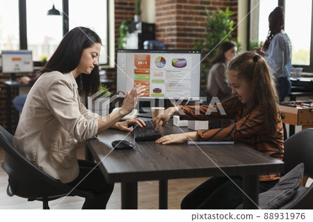 Full of energy little daughter pressing keyboard random keys while slightly irritated working mother scolding her. Naughty girl disturbing busy businesswoman while in company office workplace. Full of energy little daughter pressing keyboard random keys while slightly irritated working mother scolding her. Naughty girl disturbing busy businesswoman while in company office workplace. 88931976