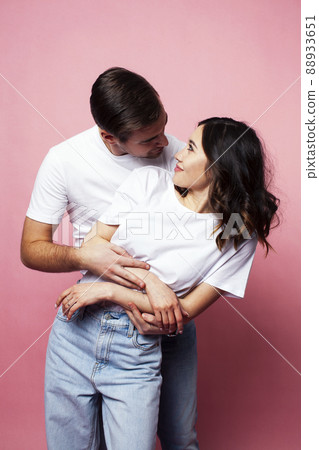 young cheerful caucasian couple together having fun on pink background, guy ang girl modern relationship, lifestyle people concept young cheerful caucasian couple together having fun on pink background, guy ang girl modern relationship, lifestyle people concept 88933651