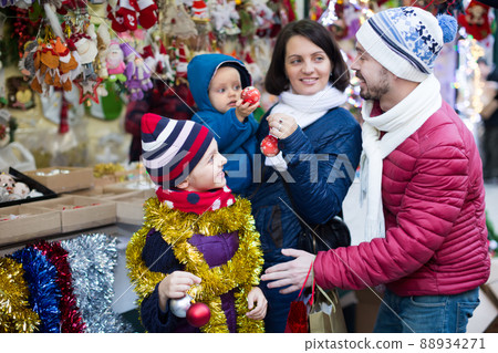 Family of four buying holidays decorations Family of four buying holidays decorations 88934271