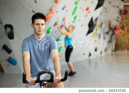 Sports guy on an exercise bike in climbing hall 88934596