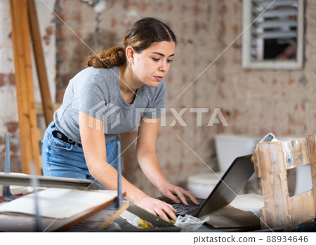Woman with laptop on indoor construction site 88934646