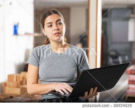 Woman with laptop on indoor construction site Woman with laptop on indoor construction site 88934820