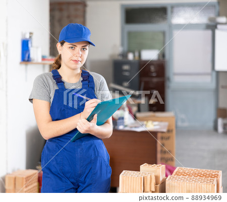 Portrait of woman builder standing in construction site Portrait of woman builder standing in construction site 88934969