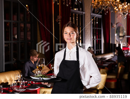 Portrait of cheerful young waitress Portrait of cheerful young waitress 88935119