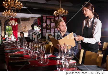 Man holding menu and ordering food 88935120