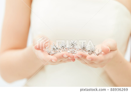 Bridal beauty shot with tiara in hand 88936269