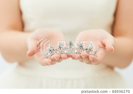 Bridal beauty shot with tiara in hand 88936270