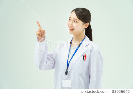 一個穿著白大褂的女人舉起手指擺姿勢 一個穿著白大褂的女人舉起手指擺姿勢 88936643