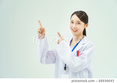 一個穿著白大褂的女人舉起手指擺姿勢 一個穿著白大褂的女人舉起手指擺姿勢 88936645