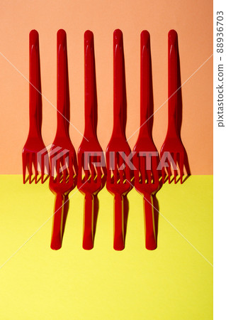 Abstract still life with red forks on a colored background Abstract still life with red forks on a colored background 88936703