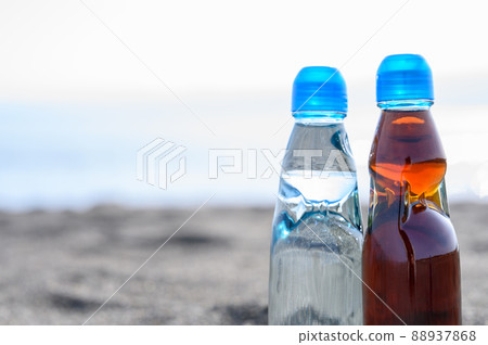 Bottled juice placed on the beach Retro sea 88937868