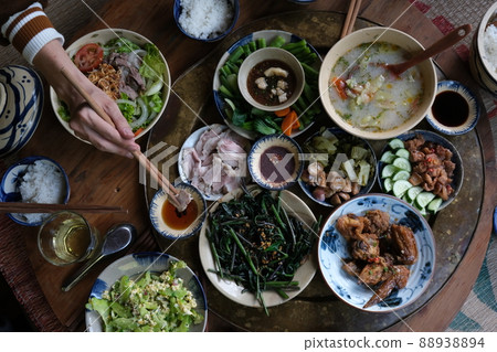 Close view of traditional vietnamese meal chicken vegetable pork and rice decorated in wooden background Close view of traditional vietnamese meal chicken vegetable pork and rice decorated in wooden background 88938894