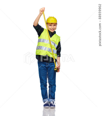 boy in construction helmet and vest with ruler 88939902