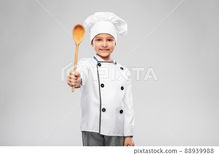 smiling little girl in chef's toque with spoon smiling little girl in chef's toque with spoon 88939988