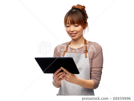 happy woman in apron with tablet pc computer 88939996