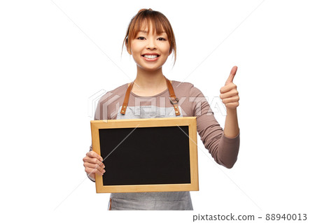 woman in apron with chalkboard showing thumbs up 88940013