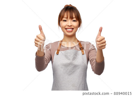 happy female chef or waitress showing thumbs up 88940015