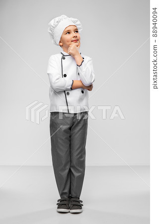 thinking little boy in chef's toque and jacket 88940094