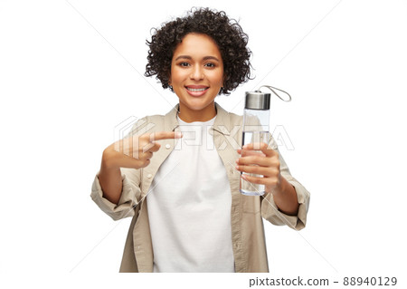happy woman with drinking water in glass bottle 88940129