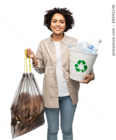 smiling woman sorting plastic and paper waste 88940146