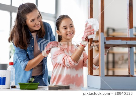 mother and daughter cleaning old table with tissue mother and daughter cleaning old table with tissue 88940153