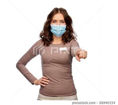 female shop assistant in mask pointing to camera female shop assistant in mask pointing to camera 88940154