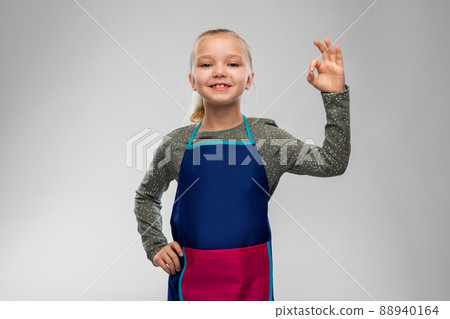 smiling little girl in apron 88940164