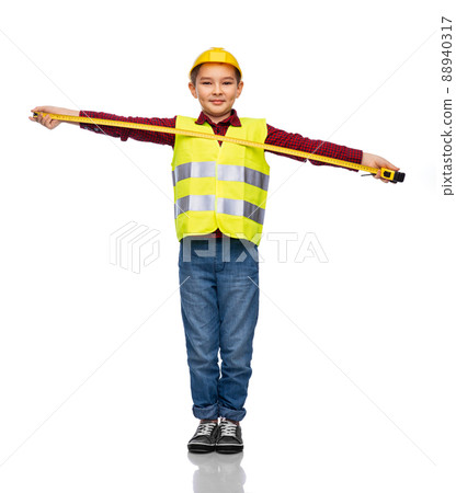 boy in construction helmet and vest with ruler boy in construction helmet and vest with ruler 88940317