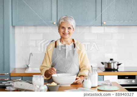 happy woman cooking food on kitchen at home happy woman cooking food on kitchen at home 88940327