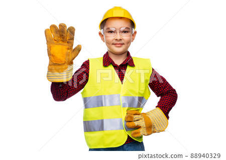 boy in protective helmet, gloves and safety vest boy in protective helmet, gloves and safety vest 88940329