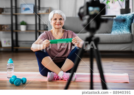 woman or fitness blogger with camera at home woman or fitness blogger with camera at home 88940391